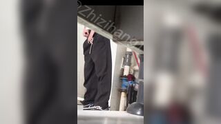 Male students are pissing in the toilet.