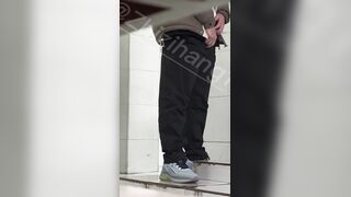 Male students are pissing in the toilet.