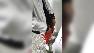 A male is pissing in the toilet 3