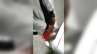 A male is pissing in the toilet 3