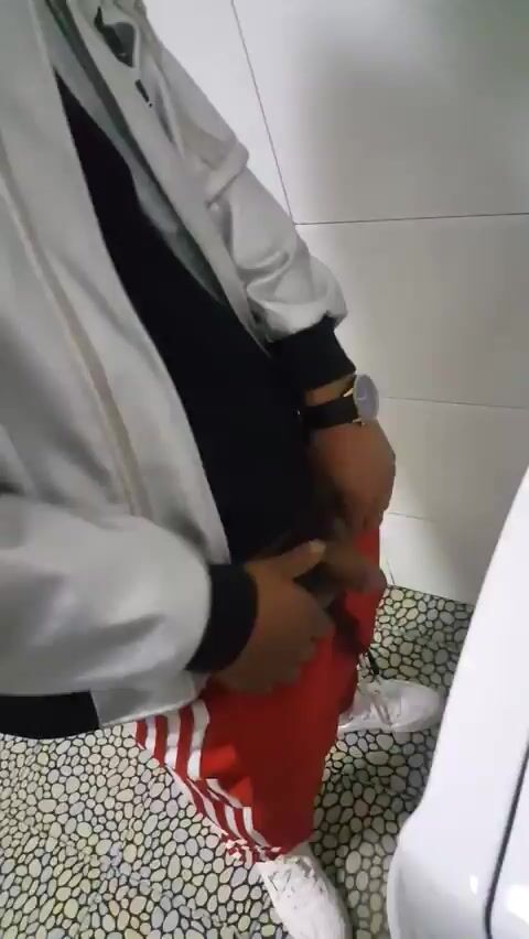 A male is pissing in the toilet 3