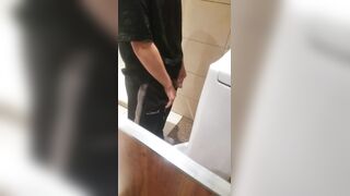 A male is pissing in the toilet5