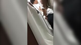 Males are pissing in the toilet.