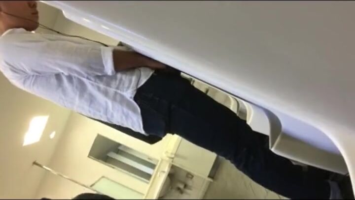 Males are pissing in the toilet.