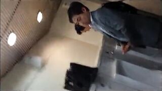 Males are pissing in the toilet.