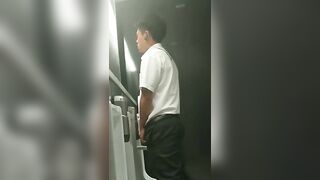 A male is pissing in the toilet.