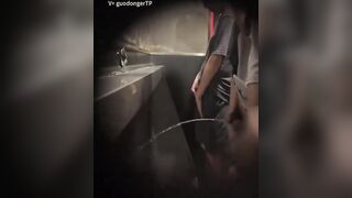 Males are pissing in the toilet.