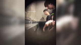 Males are pissing in the toilet.