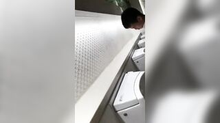 A male student is pissing in the toilet.