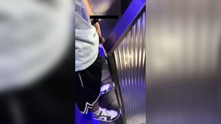 A male is pissing in the toilet.