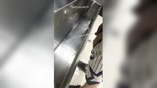 Males are pissing in the toilet.