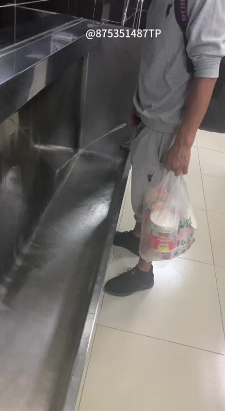 Males are pissing in the toilet.