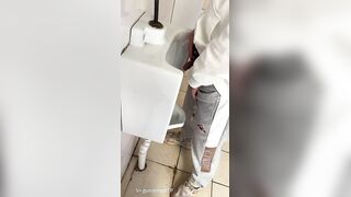 A male student is pissing in the toilet 3