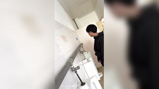 A male student is pissing in the toilet 3