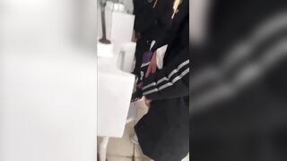 A handsome male student is pissing in the toilet.