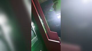 A handsome boy is pissing in the toilet.