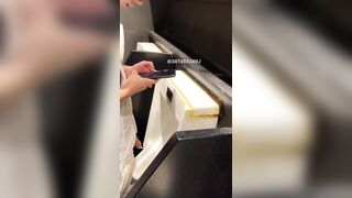 A male student is pissing in the toilet.