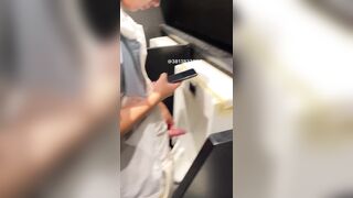 A male student is pissing in the toilet.