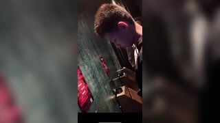 A male is pissing in the toilet.