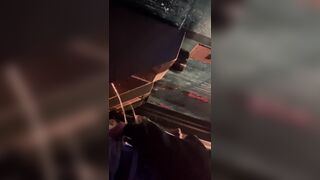 A male is pissing in the toilet.