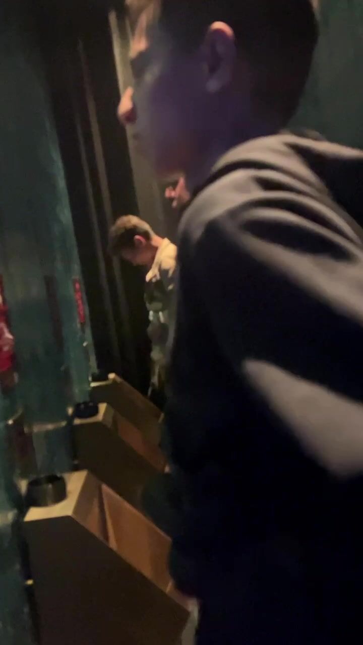 A male is pissing in the toilet.