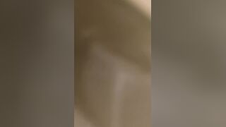 A male is pissing in the toilet.