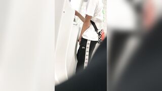 A male is pissing in the toilet.
