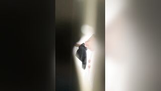 A male is pissing in the toilet.