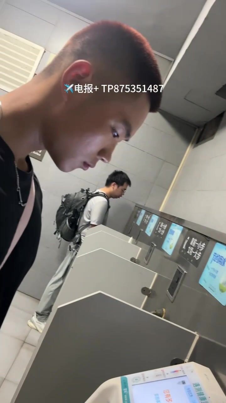 A male is pissing in the toilet.