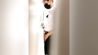 A male is pissing in the toilet.
