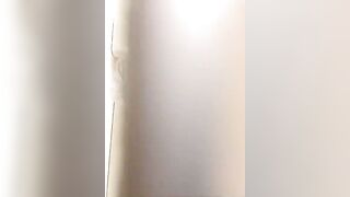 A male is pissing in the toilet.