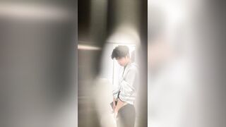 A male student is pissing in the toilet.